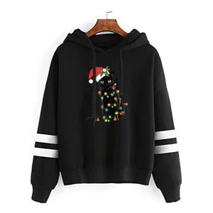 Detailed view of black hoodie featuring white sleeve stripes and cute Christmas cat graphic.