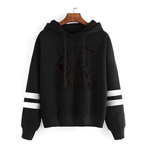 Detailed view of the black hooded sweatshirt featuring sleeve stripes and chest graphic print.