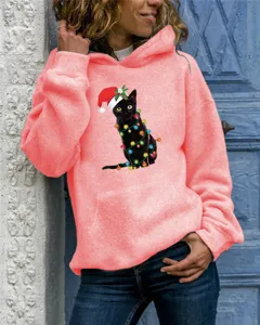 Close-up detail of the Christmas black cat graphic print on the women's cozy hoodie.
