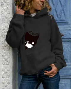 Detail shot of women's black hooded sweatshirt featuring a cute cat graphic print.