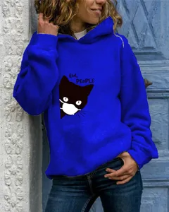 Detailed shot of a vibrant blue hoodie featuring a cute black cat and witty graphic print.