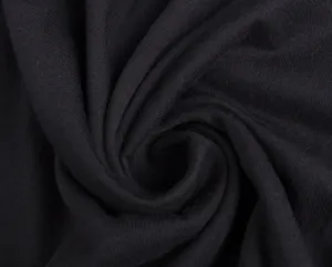 Close up of soft black cotton fabric texture, detailed knit material shot for apparel.