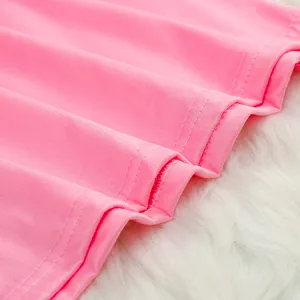 Pink fabric detail, soft material, neat stitching, close-up view of summer apparel.