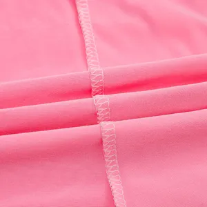 Pink fabric detail close up showing fine overlock stitching texture for women apparel.