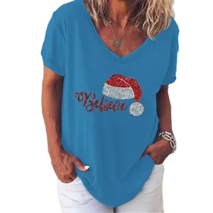 Detail view of women's blue V-neck t-shirt with glittery Christmas Santa hat Believe print.