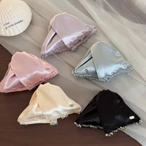 Detailed view of elegant satin triangle hair claw clips with beaded edges, multiple colors.