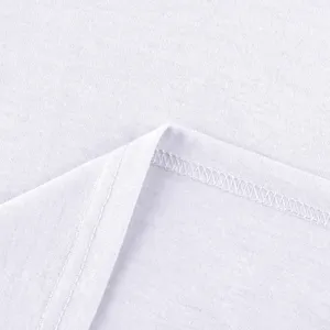 Close-up detail of white garment fabric with fine stitching and clean overlock hem lines.