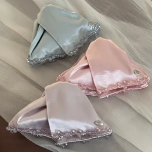 Satin triangular hair claw clips featuring delicate beaded edges and chic metallic tags.