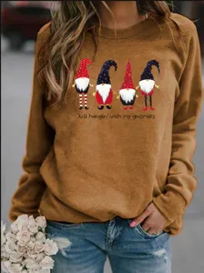 Close-up of casual crewneck sweatshirt with cute Christmas gnomes print and text.