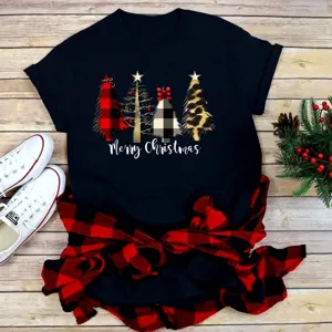 Detailed view of Christmas graphic t-shirt with plaid trees and festive flat lay setup.