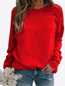 Women casual red crewneck long sleeve sweatshirt paired with ripped jeans and flowers.