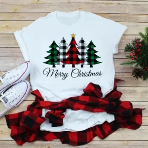 Detailed shot of white Christmas tree graphic t-shirt in festive holiday flat lay scene.