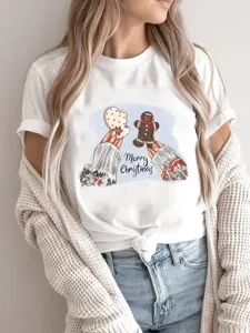 Close-up detail of the Christmas gingerbread graphic and cute text on the soft white cotton tee.
