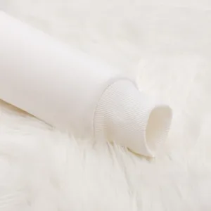 Close-up detail of plain white hoodie sleeve cuff on fluffy fur background, soft texture.