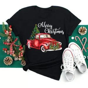Women's black short sleeve t-shirt featuring a vintage red Christmas truck graphic and holiday tree print.
