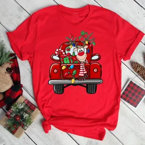 Red short sleeve t-shirt with cute Christmas reindeer and truck graphic print for holiday season.