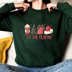 Dark green Christmas crewneck sweatshirt featuring a festive holiday graphic print.