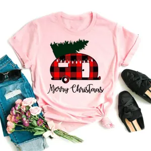 Pink graphic tee featuring a buffalo plaid Christmas camper and tree design for festive holiday wear.