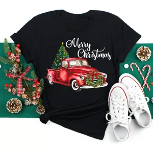 Black short sleeve Christmas t-shirt with red truck and tree graphic for holiday wear.