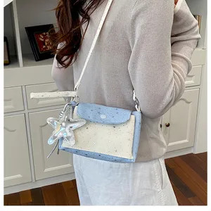 Detail view of original three-layer star crossbody bag, shiny design, portable and fresh style.