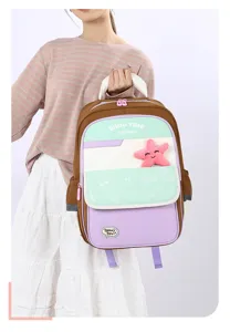 Close up of cute colorblock kids school backpack detail featuring lovely star plush decor and pockets.
