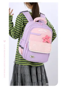 Detailed view of the stylish contrast color school backpack with cute star plush and doodle prints.