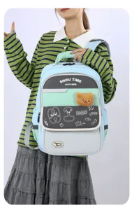 Detail view of kids school backpack showing plush bear pendant and doodle prints for daily use.