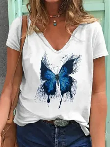 Close-up detail of women's white V-neck short sleeve t-shirt with striking blue butterfly print.