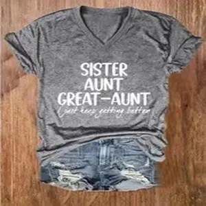 Detailed close-up view of casual grey V-neck short sleeve graphic print t-shirt and denim shorts.
