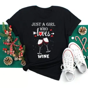 Wine graphic short sleeve black t shirt detail with festive holiday flat lay scene decor.