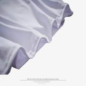 Close-up detail of white cotton-poly blend t-shirt fabric texture with neat stitching folds.