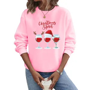 Detail shot of pink long sleeve Christmas crewneck sweatshirt with festive wine glass design.