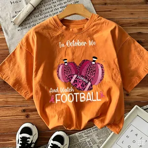 Orange short sleeve graphic t-shirt featuring fall football and pumpkin theme for women.