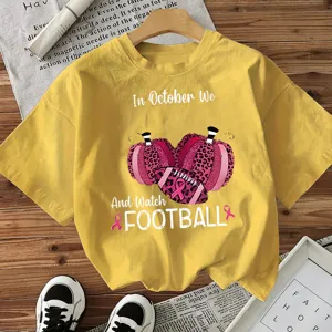 Yellow short sleeve t-shirt with football and pumpkin print for women, casual holiday top.