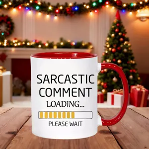Close-up of a funny ceramic coffee mug with holiday Christmas tree background and festive lights.