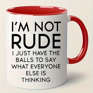 Close-up detail of a white ceramic coffee mug with red handle and funny quote text.