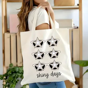 Vue détaillée du sac cabas en toile avec impression graphique de lunettes de soleil.