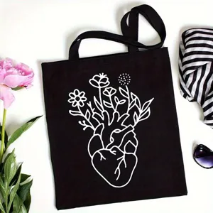 Detailed shot of black canvas tote bag featuring creative heart and floral line art print.