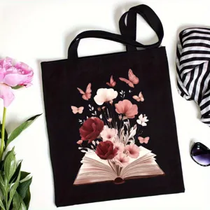 Borsa shopper in tela nera con stampa artistica di libri e fiori, borsa a spalla casual.