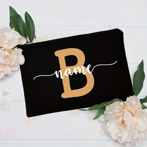 Detailed view of the customized black makeup bag featuring floral decor and custom letter design.
