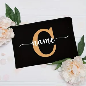 Customizable black canvas cosmetic pouch with floral decoration and personalized letter name.