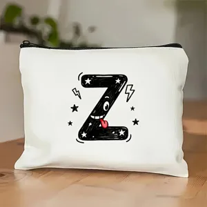 Detailopname van wit canvas tasje met leuke doodle letter Z print en zwarte ritssluiting.