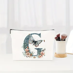 White canvas cosmetic pouch with floral butterfly letter G design, ideal travel makeup bag.