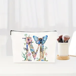 Detail shot of the elegant watercolor floral letter M cosmetic bag close-up view.