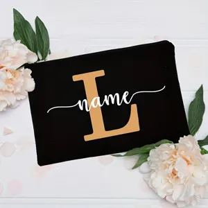 Custom black canvas cosmetic pouch featuring initial letter and floral background detail.