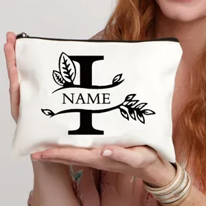 Gepersonaliseerd canvas make-up tasje met bloemletterontwerp, stijlvolle cosmetische tas met rits.