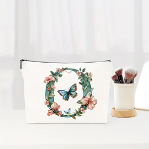 Floral letter O makeup pouch detail, canvas cosmetic bag with butterfly, elegant gift.