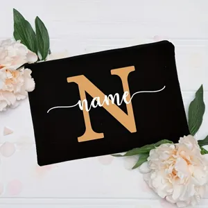 Customizable black canvas makeup pouch with elegant floral decor and alphabet print for women.