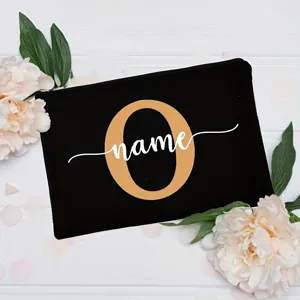 Close-up detail of custom letter black canvas pouch decorated with floral background.