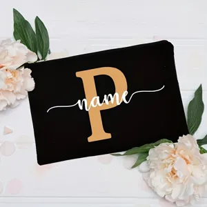 Custom letter cosmetic bag with floral decor, chic black canvas pouch for daily use.